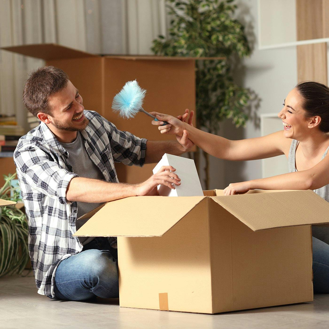 A couple unboxing belongings in a new home