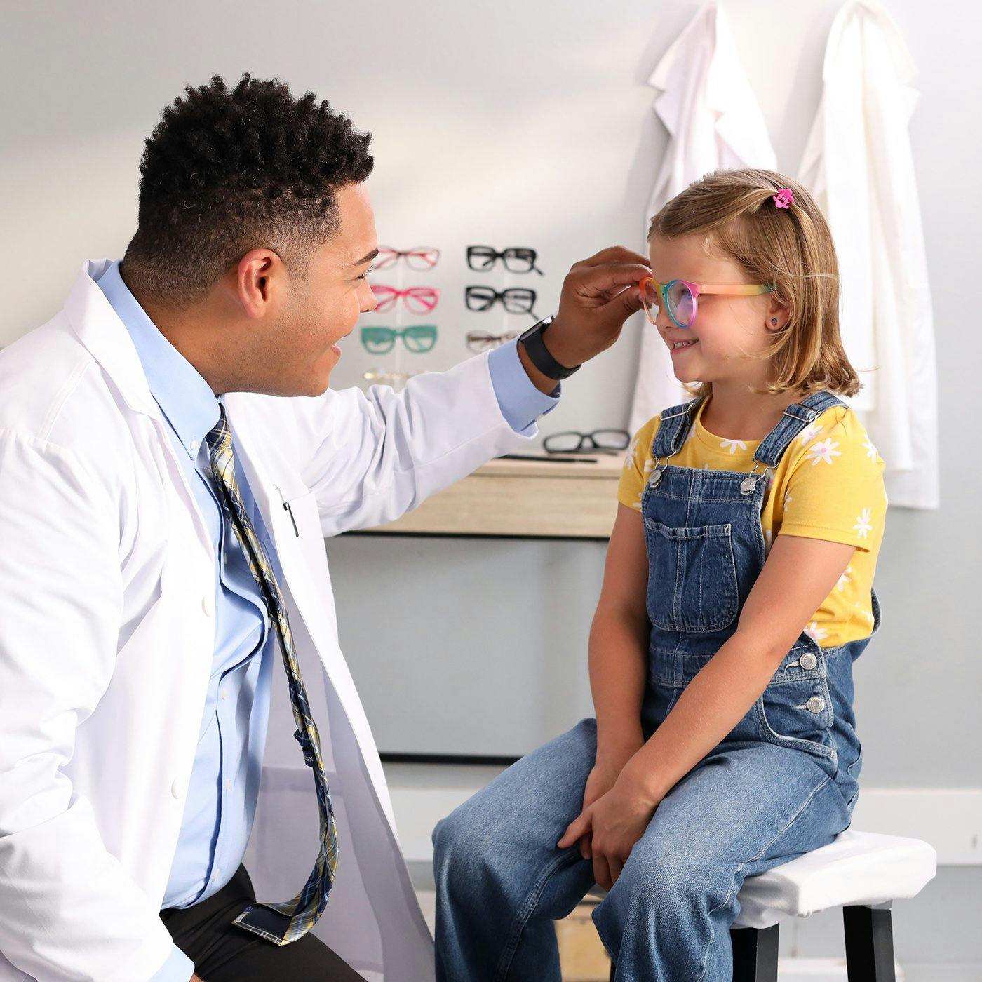 An eye doctor with a young patient